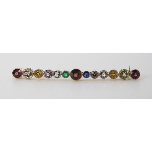 816 - A LARGE RAINBOW GEM SET BROOCH to include garnets, sapphire and emerald, set in yellow metal ga... 