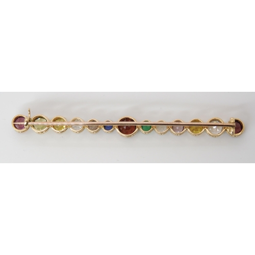 816 - A LARGE RAINBOW GEM SET BROOCH to include garnets, sapphire and emerald, set in yellow metal ga... 