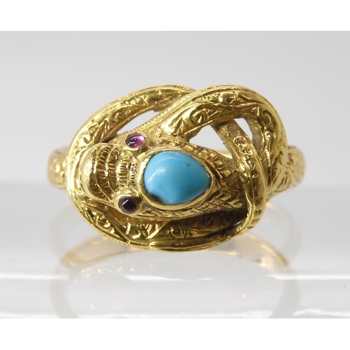 820 - A SNAKE RING WITH RUBY EYES engraved throughout with a scroll pattern, the top of the head set ... 