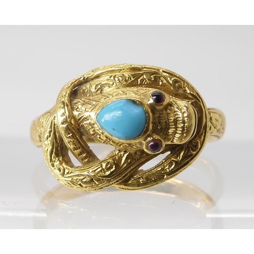 820 - A SNAKE RING WITH RUBY EYES engraved throughout with a scroll pattern, the top of the head set ... 