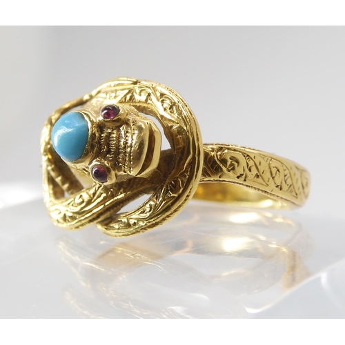 820 - A SNAKE RING WITH RUBY EYES engraved throughout with a scroll pattern, the top of the head set ... 