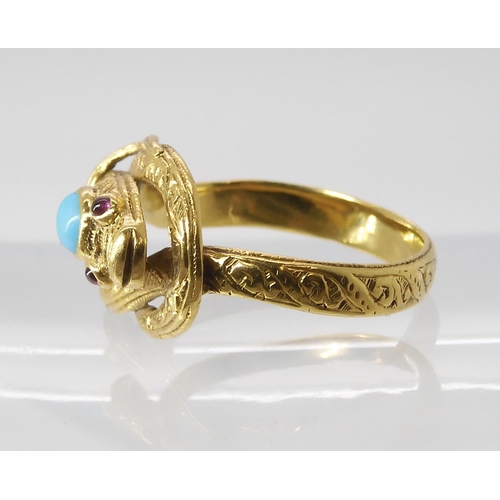 820 - A SNAKE RING WITH RUBY EYES engraved throughout with a scroll pattern, the top of the head set ... 