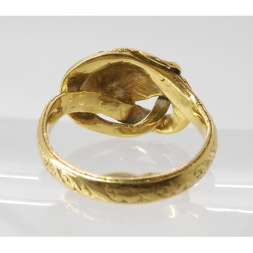 820 - A SNAKE RING WITH RUBY EYES engraved throughout with a scroll pattern, the top of the head set ... 