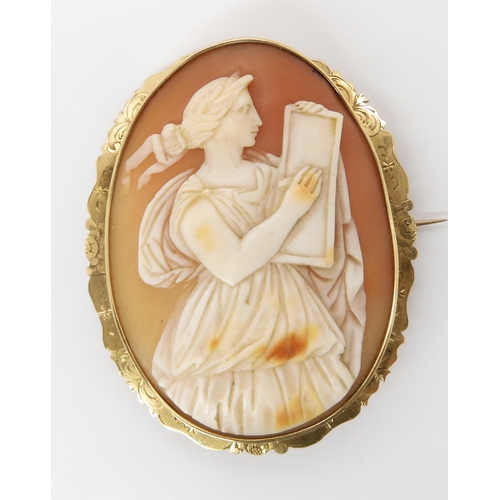 828 - A SHELL CAMEO OF A SCHOLARset in a yellow metal mount engraved with flowers. Dimensions of the cameo... 