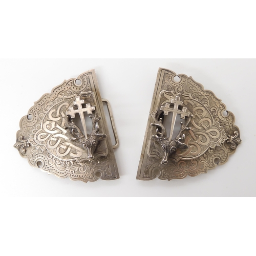 831 - A SILVER STAG'S HEAD BUCKLEwith all over knotwork and floral engraving, and applied fitchee crosses.... 