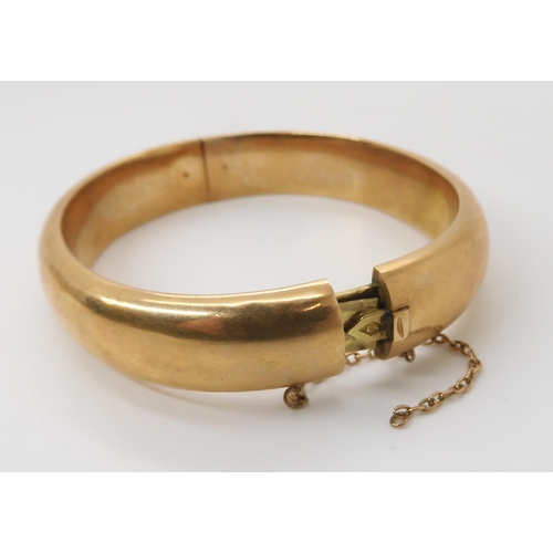 833 - A 15CT GOLD BANGLEof plain design, inner diameter 5.7cm x 4.9cm, width approx 1.2cm, weight 21.2gms... 