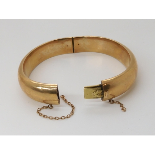 833 - A 15CT GOLD BANGLEof plain design, inner diameter 5.7cm x 4.9cm, width approx 1.2cm, weight 21.2gms... 