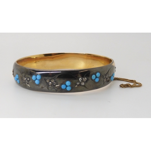 839 - A DIAMOND & TURQUOISE BANGLEthe area set with diamonds is dramatically blackened as a design fea... 