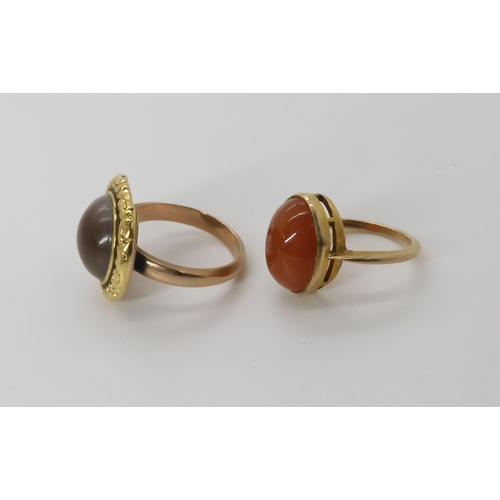 841 - TWO VINTAGE RINGSan operculum shell ring in a Georgian style yellow metal scroll and flower patterne... 