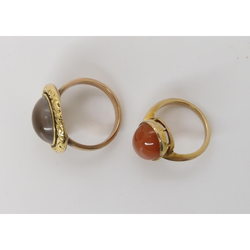 841 - TWO VINTAGE RINGSan operculum shell ring in a Georgian style yellow metal scroll and flower patterne... 