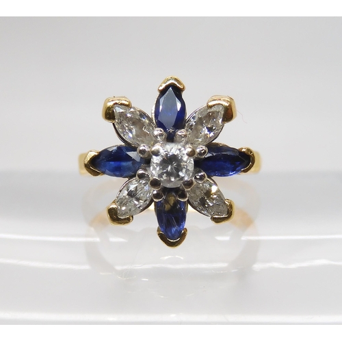 845 - A SAPPHIRE AND DIAMOND FLOWER RINGset with four marquis diamonds and a brilliant cut, with an estima... 