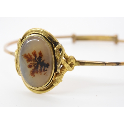 848 - A DENDRITIC AGATE SNAKE BANGLEthe setting of the agate has a coiled snake to each side. Made in unha... 