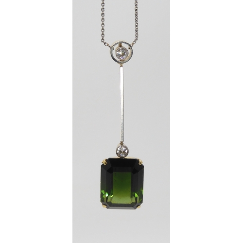 853 - A 15CT TOURMALINE AND DIAMOND PENDANTmounted in yellow and white metal, the emerald cut tourmaline m... 