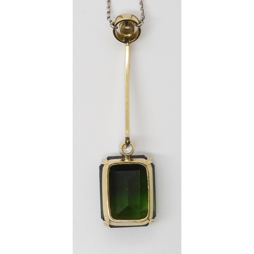 853 - A 15CT TOURMALINE AND DIAMOND PENDANTmounted in yellow and white metal, the emerald cut tourmaline m... 