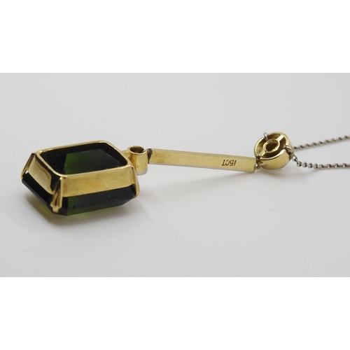 853 - A 15CT TOURMALINE AND DIAMOND PENDANTmounted in yellow and white metal, the emerald cut tourmaline m... 