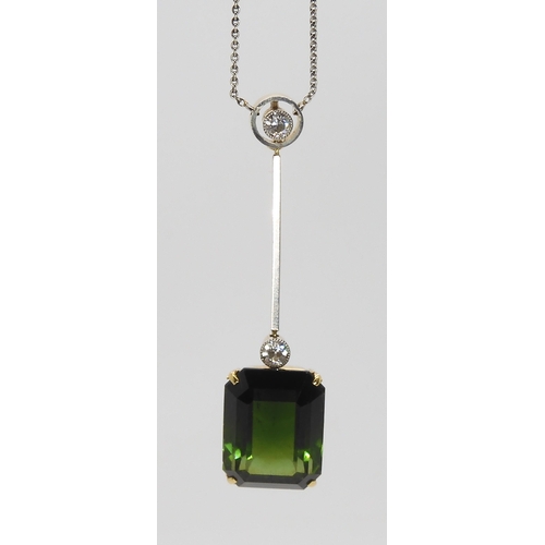 853 - A 15CT TOURMALINE AND DIAMOND PENDANTmounted in yellow and white metal, the emerald cut tourmaline m... 