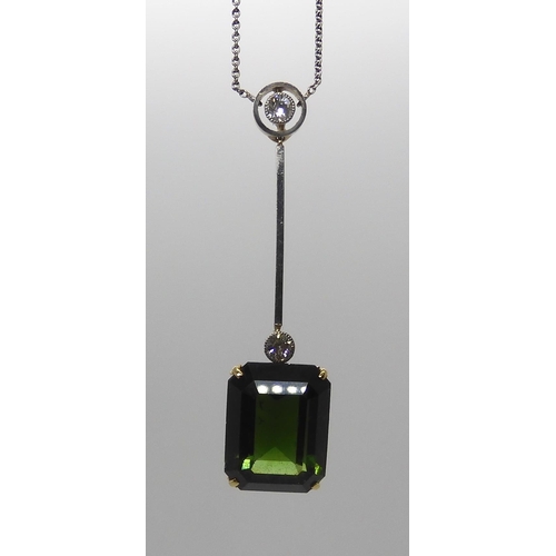 853 - A 15CT TOURMALINE AND DIAMOND PENDANTmounted in yellow and white metal, the emerald cut tourmaline m... 