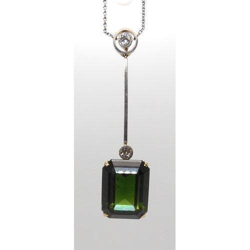 853 - A 15CT TOURMALINE AND DIAMOND PENDANTmounted in yellow and white metal, the emerald cut tourmaline m... 