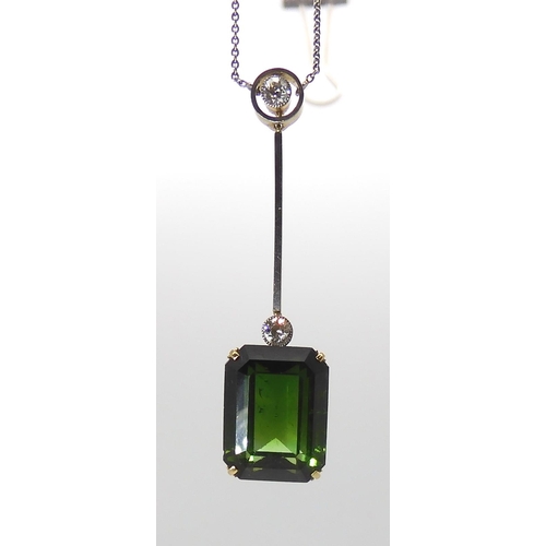 853 - A 15CT TOURMALINE AND DIAMOND PENDANTmounted in yellow and white metal, the emerald cut tourmaline m... 