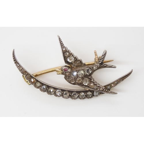 856 - A DIAMOND SET SWALLOW AND MOON BROOCHthe yellow and white metal mount set throughout in rose cut dia... 