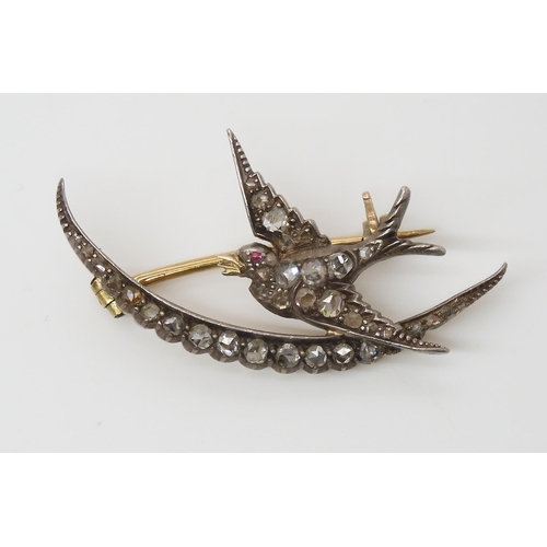 856 - A DIAMOND SET SWALLOW AND MOON BROOCHthe yellow and white metal mount set throughout in rose cut dia... 