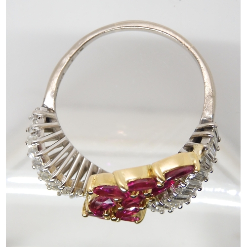 878 - A RUBY AND DIAMOND STATEMENT RINGset throughout in 18ct white gold, the baguette cut diamonds are es... 