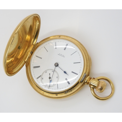 903 - AN 18CT GOLD WALTHAM FULL HUNTER with white enamelled dial with black Roman numerals and subsidiary ... 