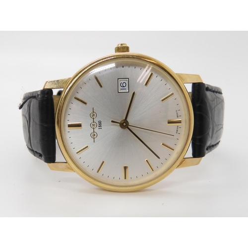 909 - A 9CT GOLD WHW QUARTZ WRISTWATCHwith brushed silvered dial, gold baton numerals and a date aperture.... 