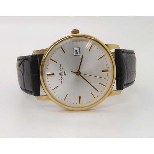 909 - A 9CT GOLD WHW QUARTZ WRISTWATCHwith brushed silvered dial, gold baton numerals and a date aperture.... 