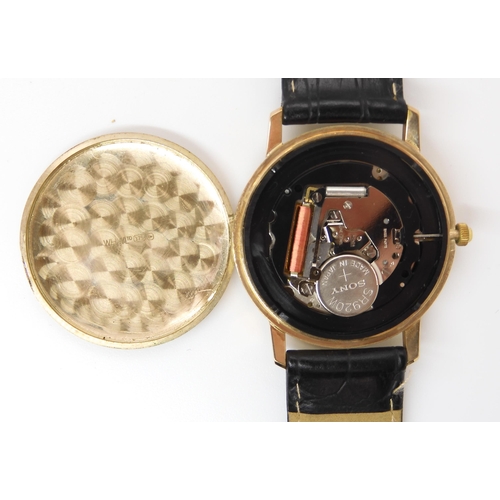 909 - A 9CT GOLD WHW QUARTZ WRISTWATCHwith brushed silvered dial, gold baton numerals and a date aperture.... 