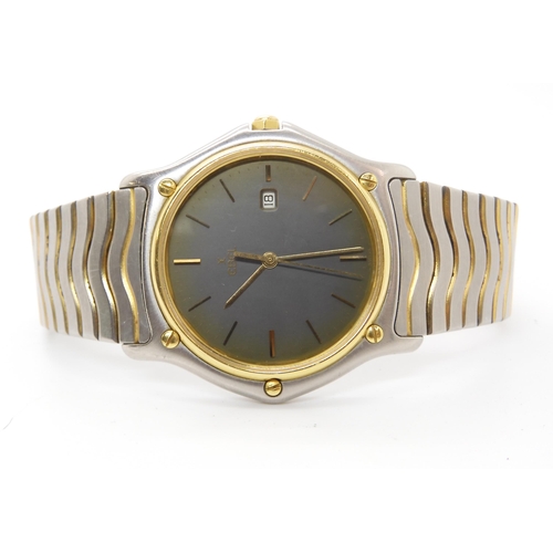 914 - A GENTS EBEL WRISTWATCHwith gold bezel grey dial with gold coloured baton numerals and a date appert... 