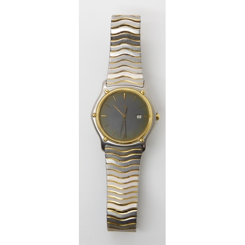 914 - A GENTS EBEL WRISTWATCHwith gold bezel grey dial with gold coloured baton numerals and a date appert... 