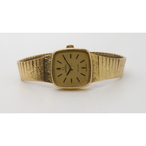 922 - A 9CT GOLD LADIES OMEGA DE VILLEwith integral textured strap. Dimensions of the case 2cm x 2cm, leng... 