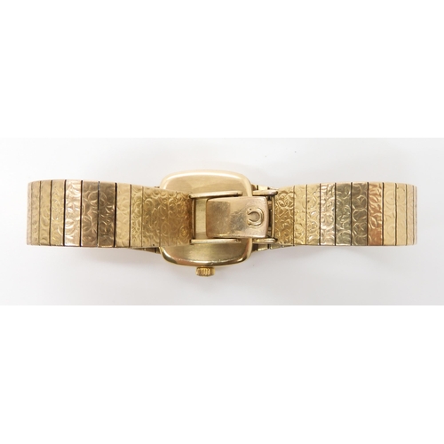 922 - A 9CT GOLD LADIES OMEGA DE VILLEwith integral textured strap. Dimensions of the case 2cm x 2cm, leng... 