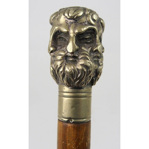 606 - AN EARLY 20th CENTURY WHITE-METAL HANDLED WALKING CANE FORMED AS THE FACES OF SIX GREEK GODSstamped ... 