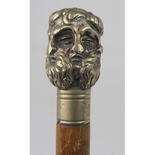 606 - AN EARLY 20th CENTURY WHITE-METAL HANDLED WALKING CANE FORMED AS THE FACES OF SIX GREEK GODSstamped ... 