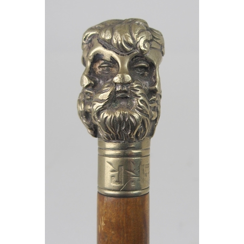 606 - AN EARLY 20th CENTURY WHITE-METAL HANDLED WALKING CANE FORMED AS THE FACES OF SIX GREEK GODSstamped ... 