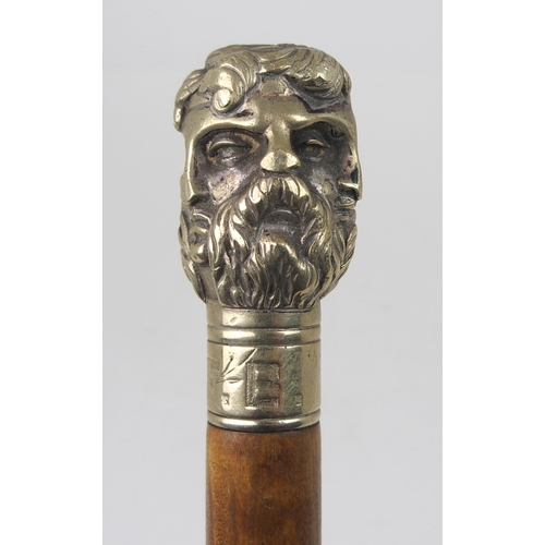 606 - AN EARLY 20th CENTURY WHITE-METAL HANDLED WALKING CANE FORMED AS THE FACES OF SIX GREEK GODSstamped ... 