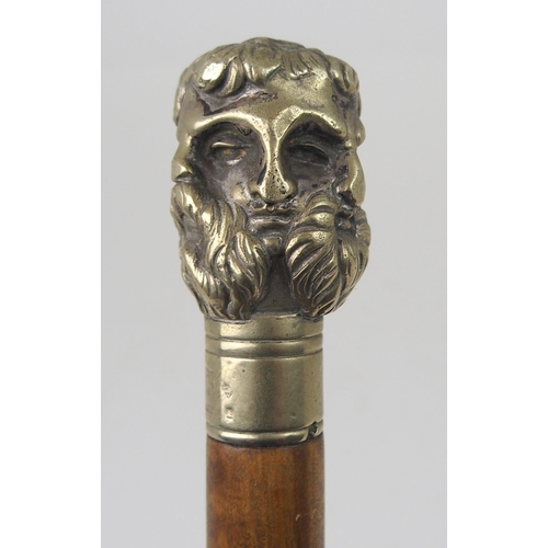 606 - AN EARLY 20th CENTURY WHITE-METAL HANDLED WALKING CANE FORMED AS THE FACES OF SIX GREEK GODSstamped ... 