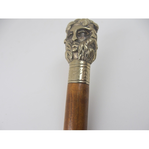 606 - AN EARLY 20th CENTURY WHITE-METAL HANDLED WALKING CANE FORMED AS THE FACES OF SIX GREEK GODSstamped ... 