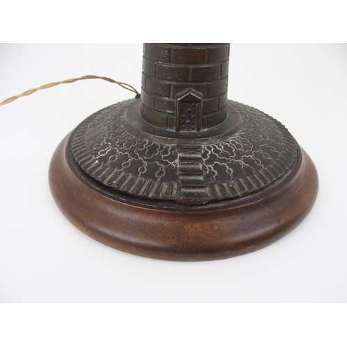 608 - A VINTAGE CAST BRASS LIGHTHOUSE TABLE LAMPfitted for electricity, on circular wooden base, 37cm high... 