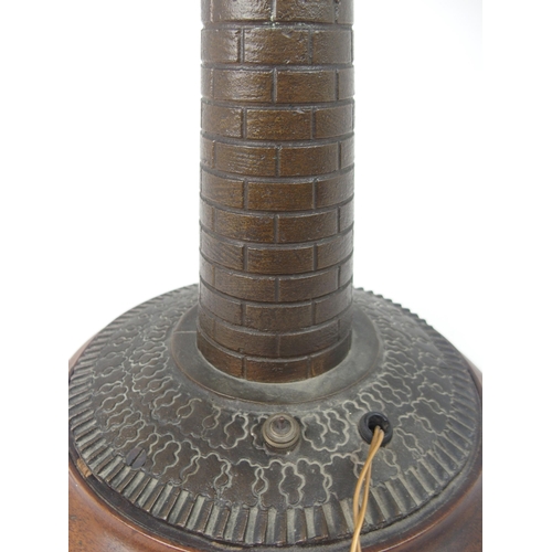 608 - A VINTAGE CAST BRASS LIGHTHOUSE TABLE LAMPfitted for electricity, on circular wooden base, 37cm high... 