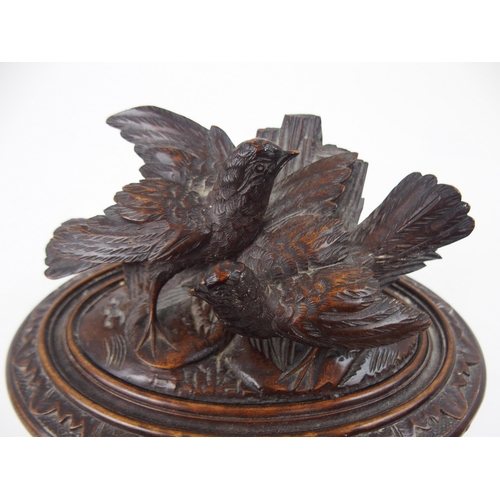 615 - A VICTORIAN OVAL BLACK FOREST JEWELLERY CASKETthe lid surmounted by carved birds, 21cm wide... 