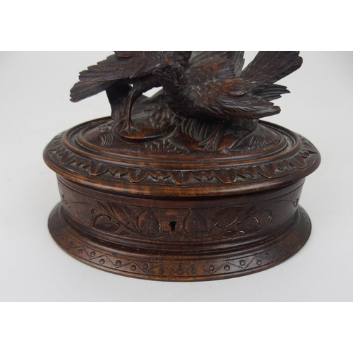 615 - A VICTORIAN OVAL BLACK FOREST JEWELLERY CASKETthe lid surmounted by carved birds, 21cm wide... 