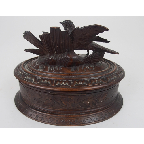 615 - A VICTORIAN OVAL BLACK FOREST JEWELLERY CASKETthe lid surmounted by carved birds, 21cm wide... 