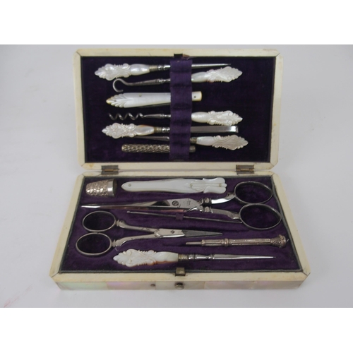 620 - A MOTHER OF PEARL SEWING KITwith mother of pearl accessories, 15cm, and another velvet sewing case w... 