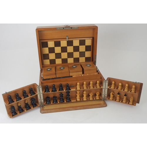 626 - A VICTORIAN GAMES COMPENDIUMwith hinged lid and twin flap doors, with associated chess pieces, draug... 