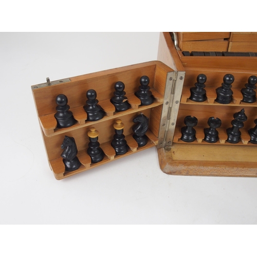 626 - A VICTORIAN GAMES COMPENDIUMwith hinged lid and twin flap doors, with associated chess pieces, draug... 