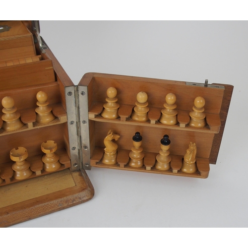 626 - A VICTORIAN GAMES COMPENDIUMwith hinged lid and twin flap doors, with associated chess pieces, draug... 