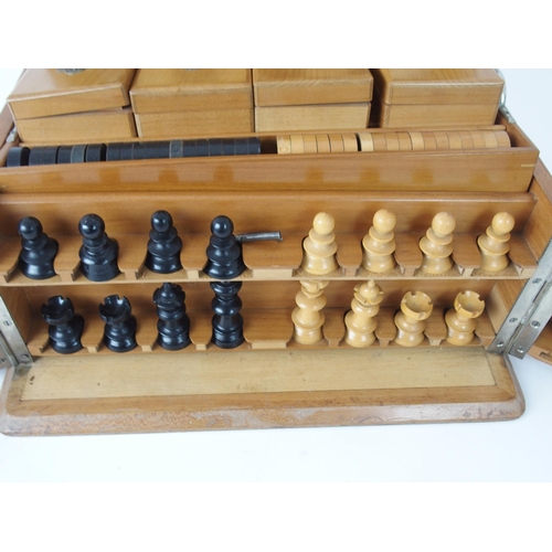 626 - A VICTORIAN GAMES COMPENDIUMwith hinged lid and twin flap doors, with associated chess pieces, draug... 